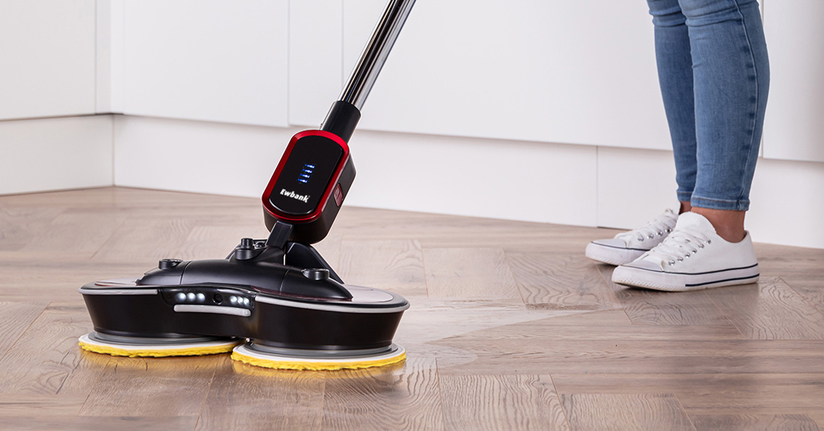 A person polishing a hard floor