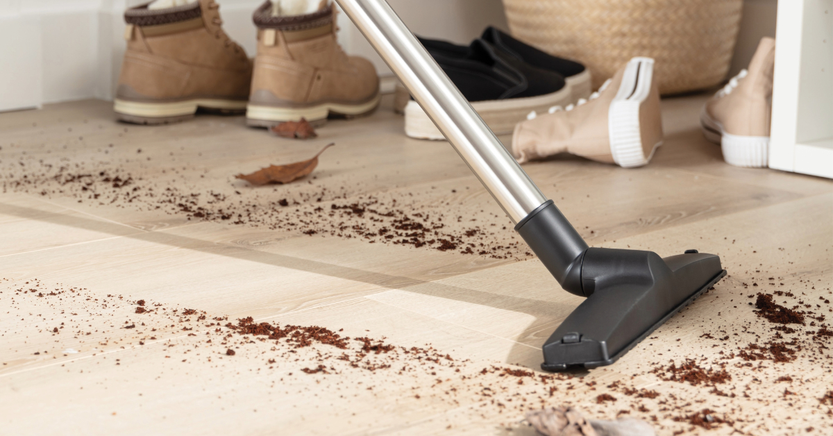 A vacuum cleaning dirt off a hard floor